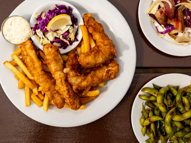 Fish and chips, smoked meat, and edamame dishes.
