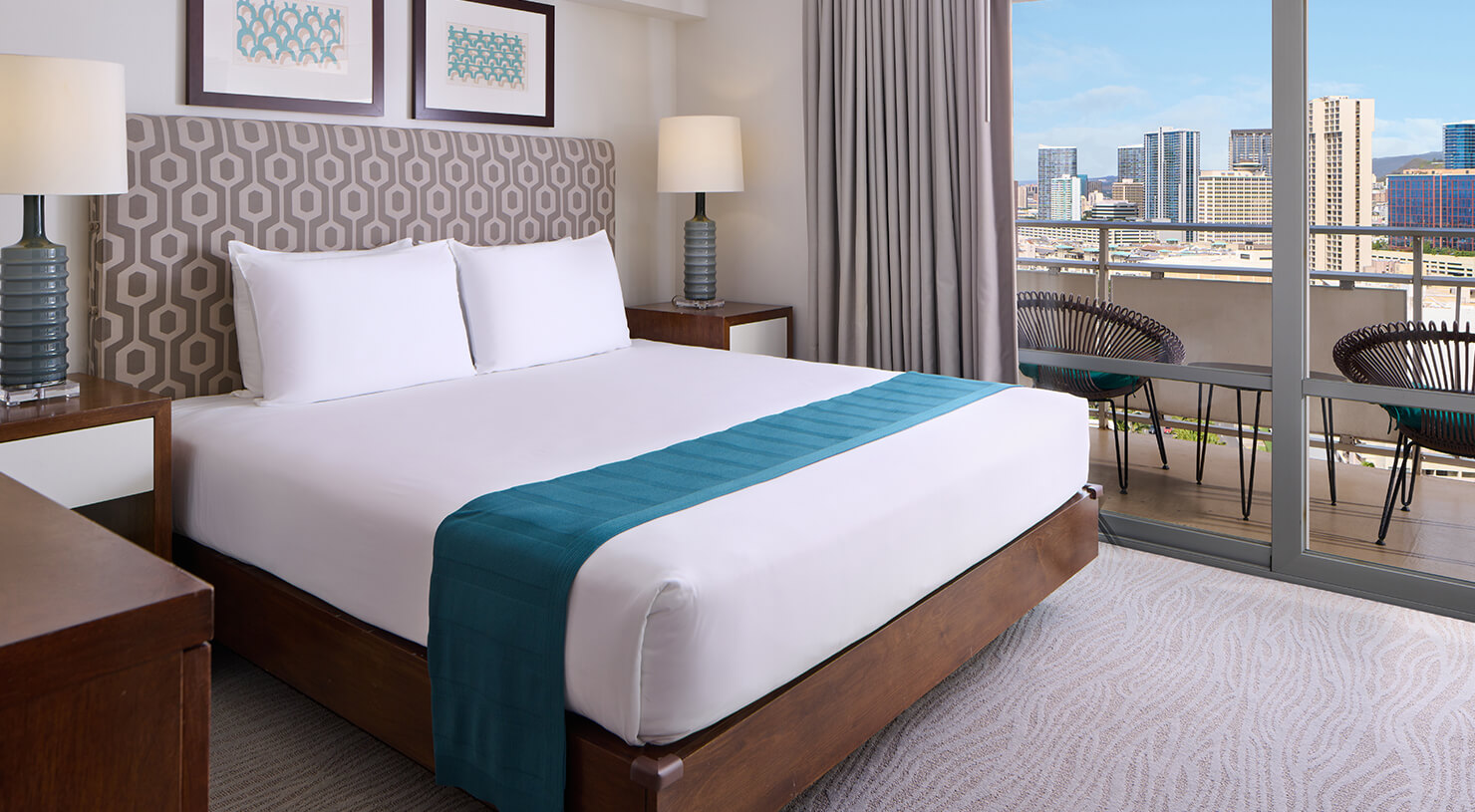 Bed, nightstands, lamps, and balcony.