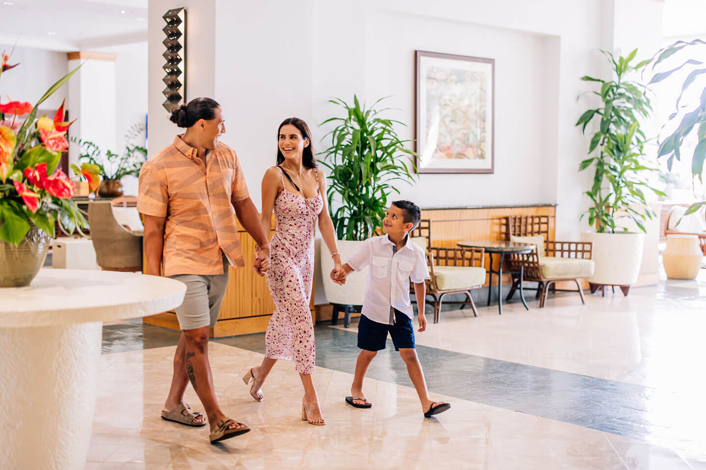 Family walking through hotel lobby.
