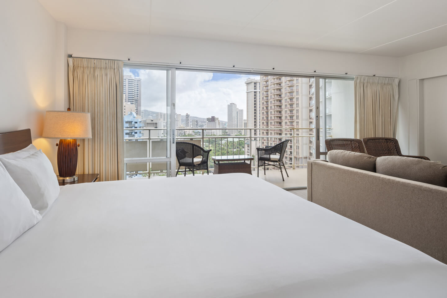 Mountain View Suite Bedroom with king bed, private balcony, and a separate seating area
