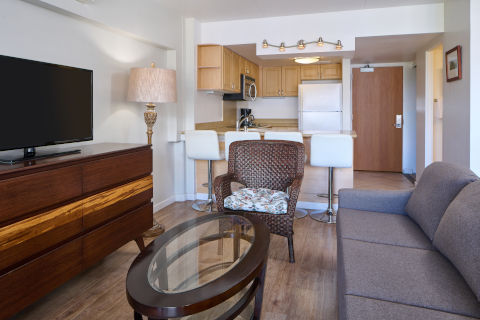 Ilikai LIte Mountain View Jr Suite Living Area with LCD TV, coffee table and a separate seating area 