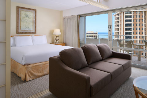 Ilikai Lite Ocean View Suite with the comforts of a full kitchen, bed, separate seating area, a private balcony to enjoy the views