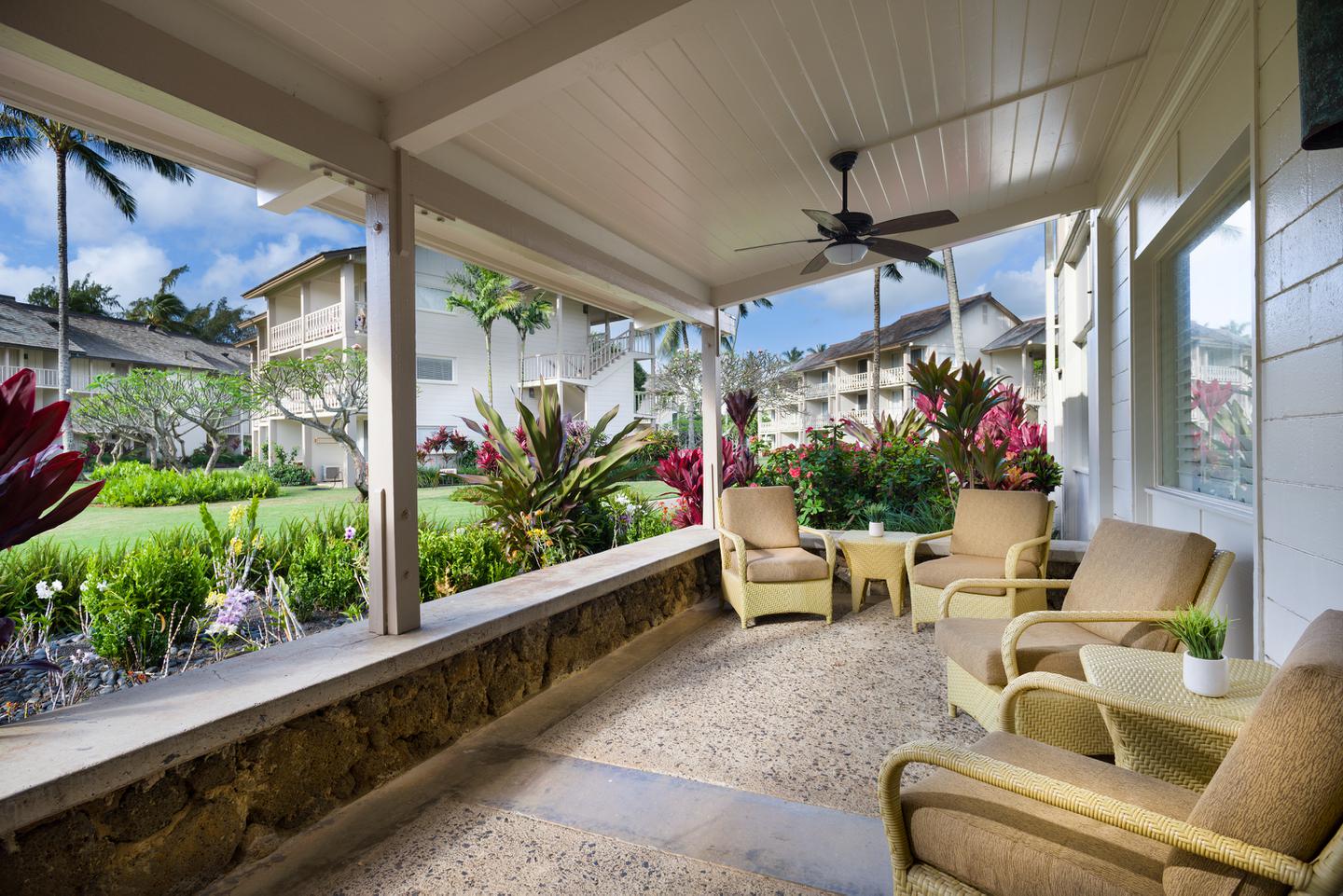 Lobby patio with seating in garden setting.