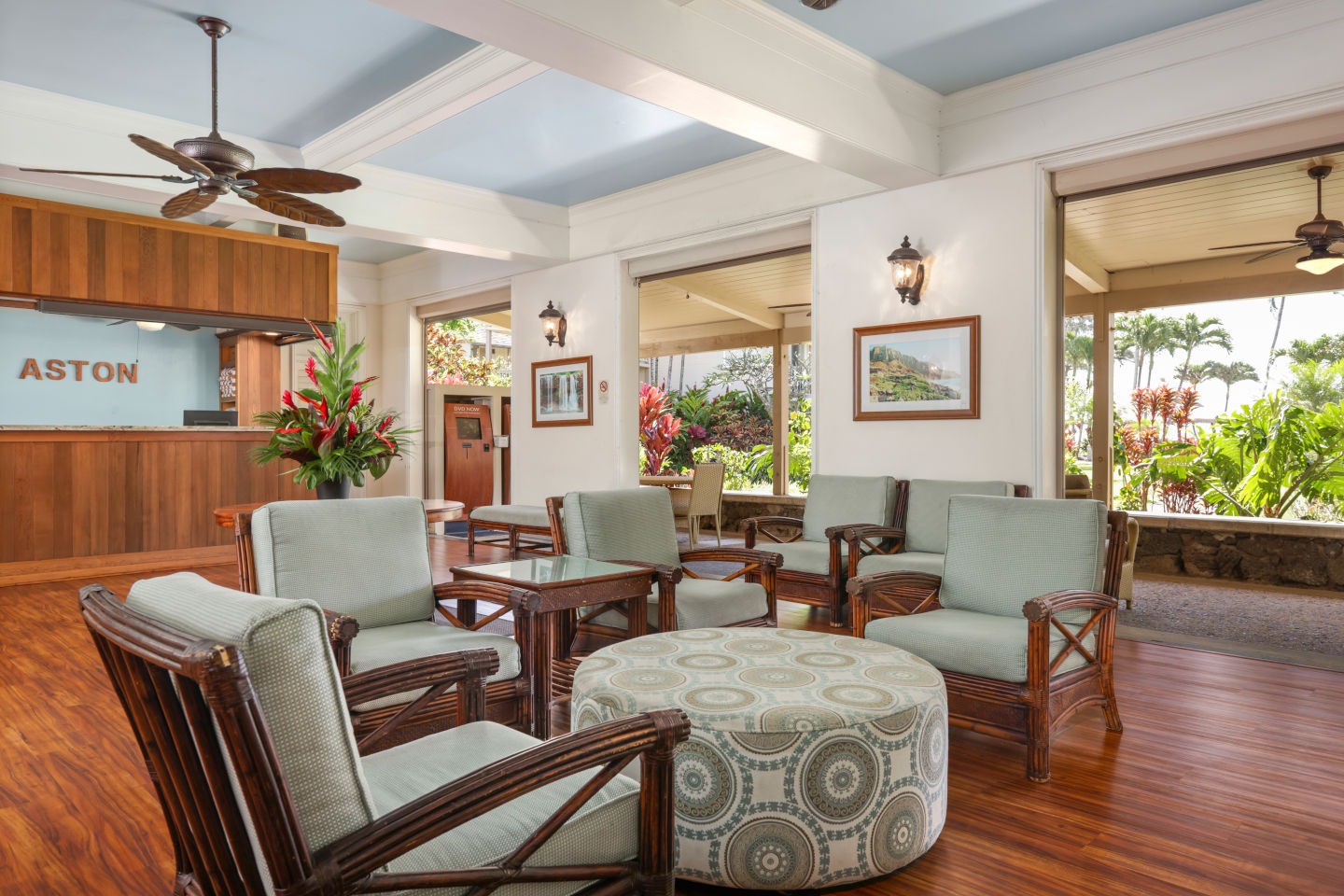 Lobby seating area with circular table at the Aston Islander on the Beach .