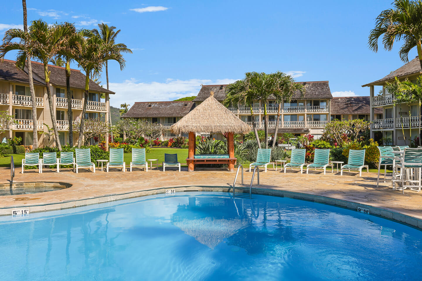 Resort pool and jet spa with lounge chairs on the deck
