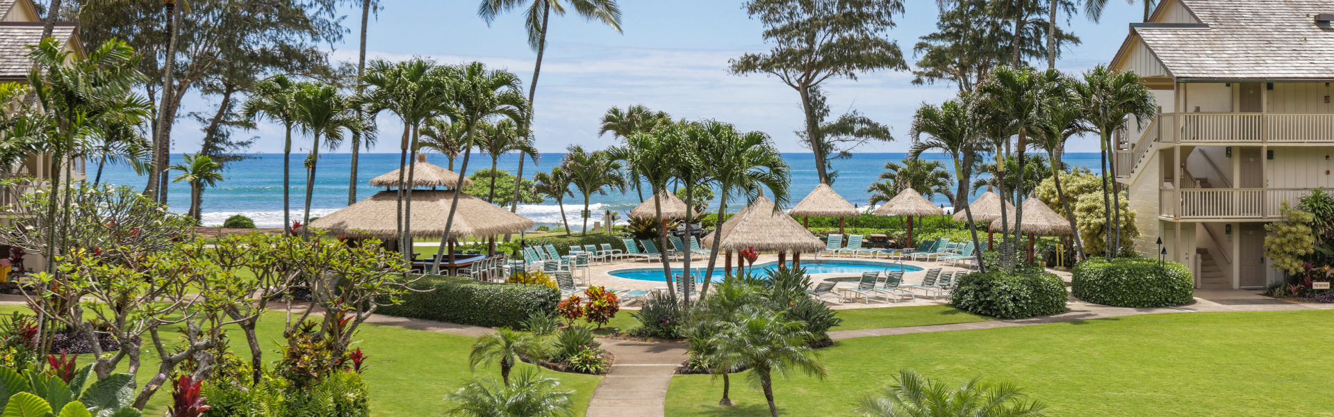 Couple relaxing with drinks on pool loungers