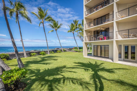 Resort exterior facing the ocean at lush green lawn area