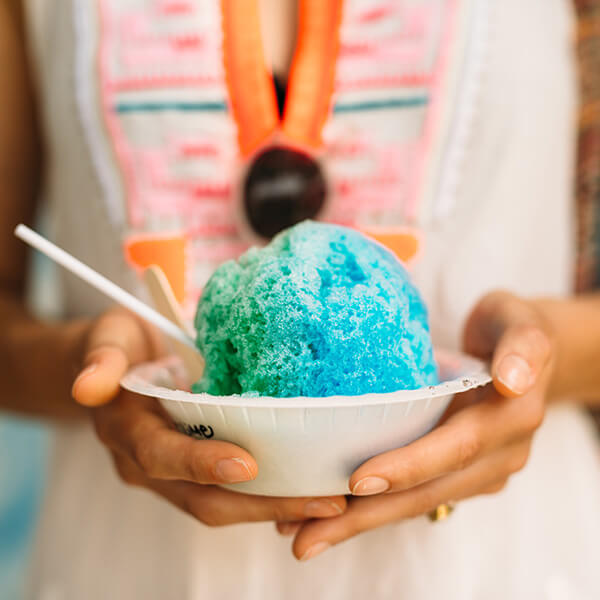 Hands holding shave ice in Kailua-Kona Hawaii Island