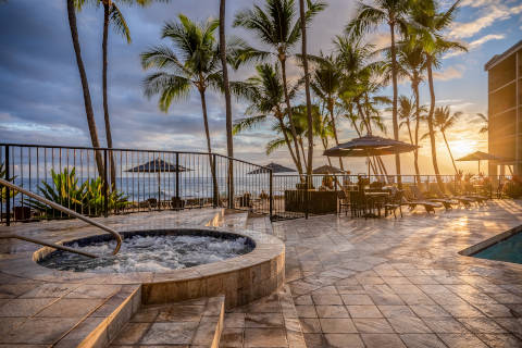 View from near the whirlpool at the pool deck with the sun setting near the horizon