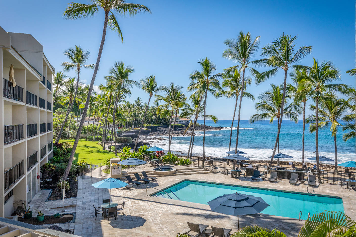 View of pool and ocean from balcony.