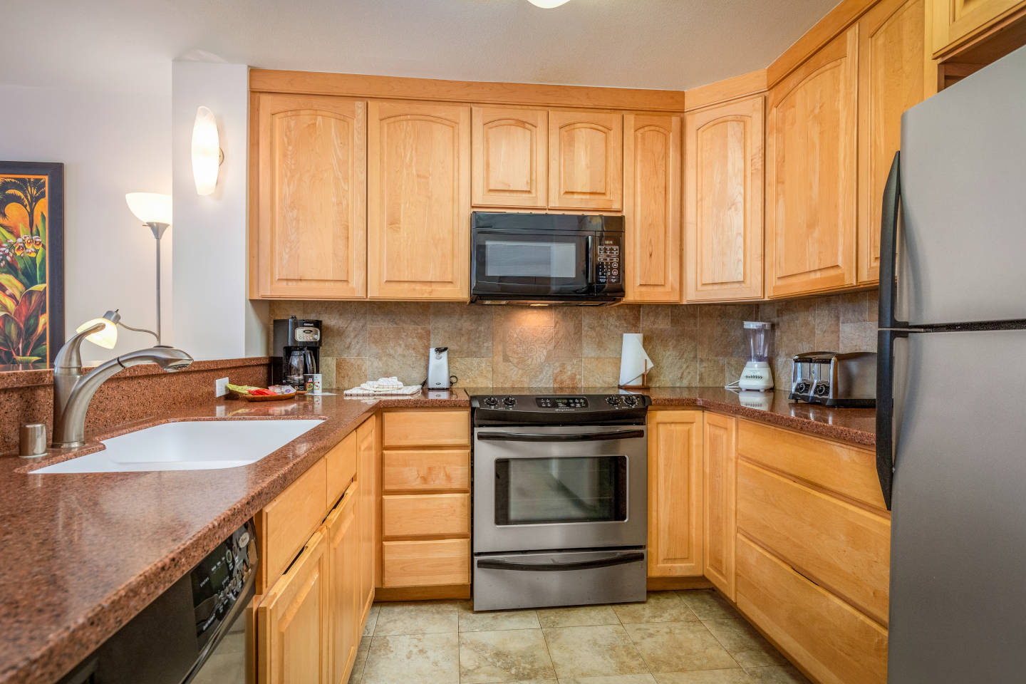 Kitchen with stove, oven, kicrowave, sink, counters, cabinets, and refrigerator