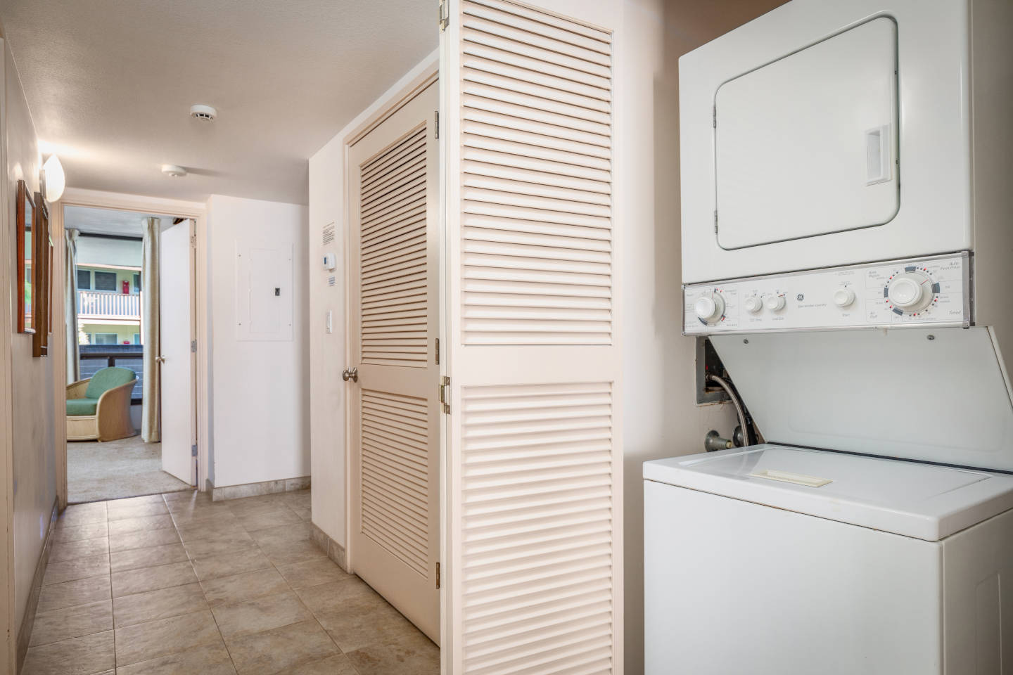 In-room washer and dryer single unit in hallway closet.