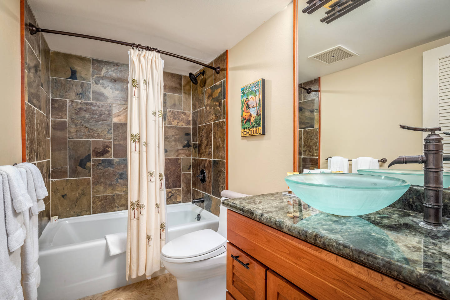 Bathroom with full soaking tub and a glass wash basin