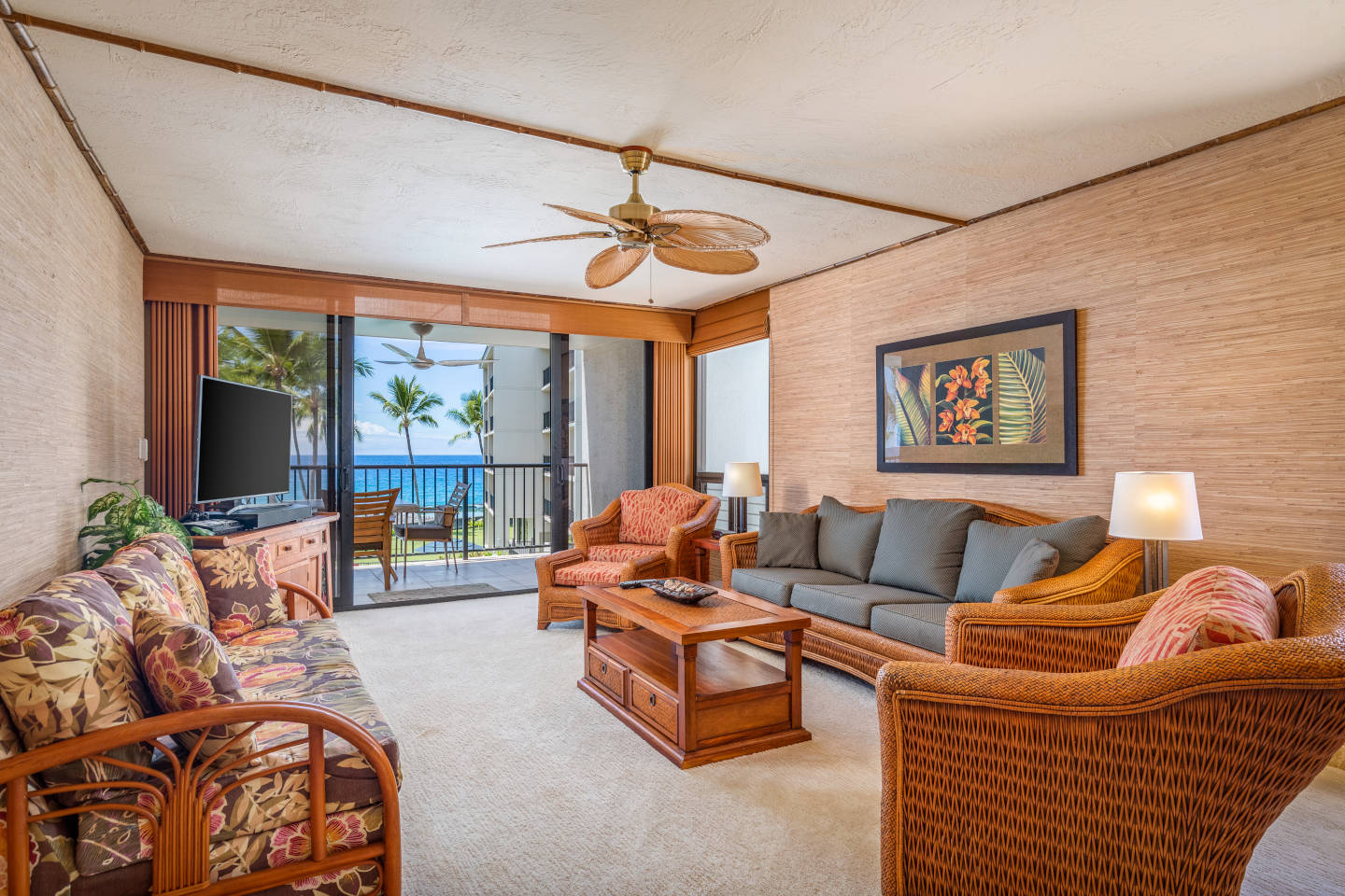 Living space with two sofas and matching lounge chairs, coffee table and flat screen television  