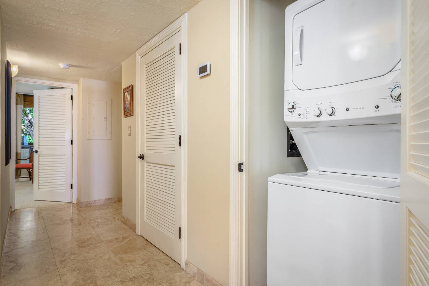 Washer and dryer combo unit in-room in the hallway area.