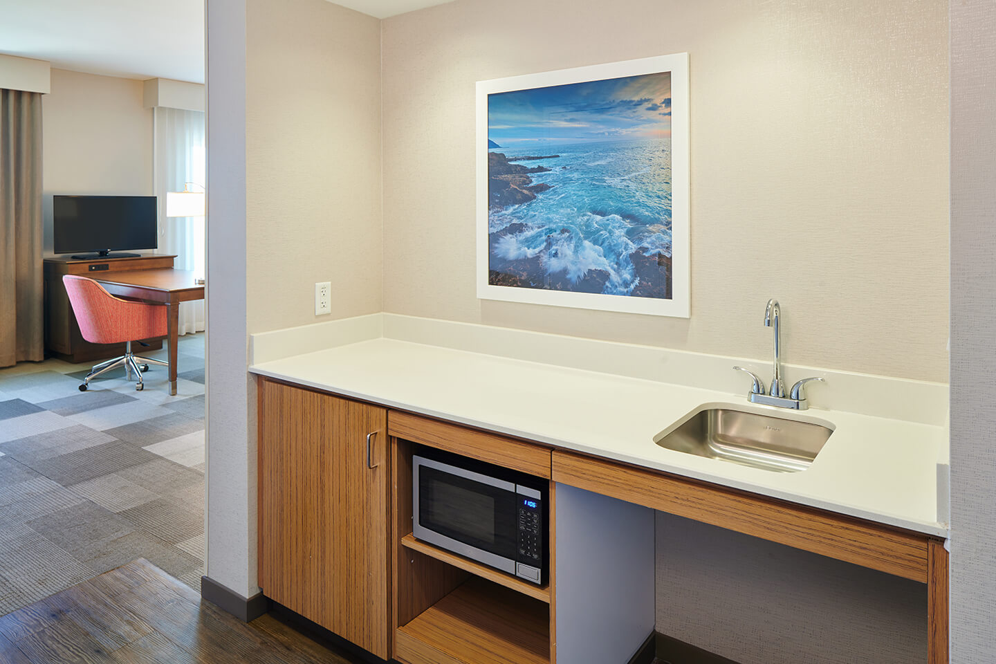 Wet bar area with small sink, counter, refrigerator