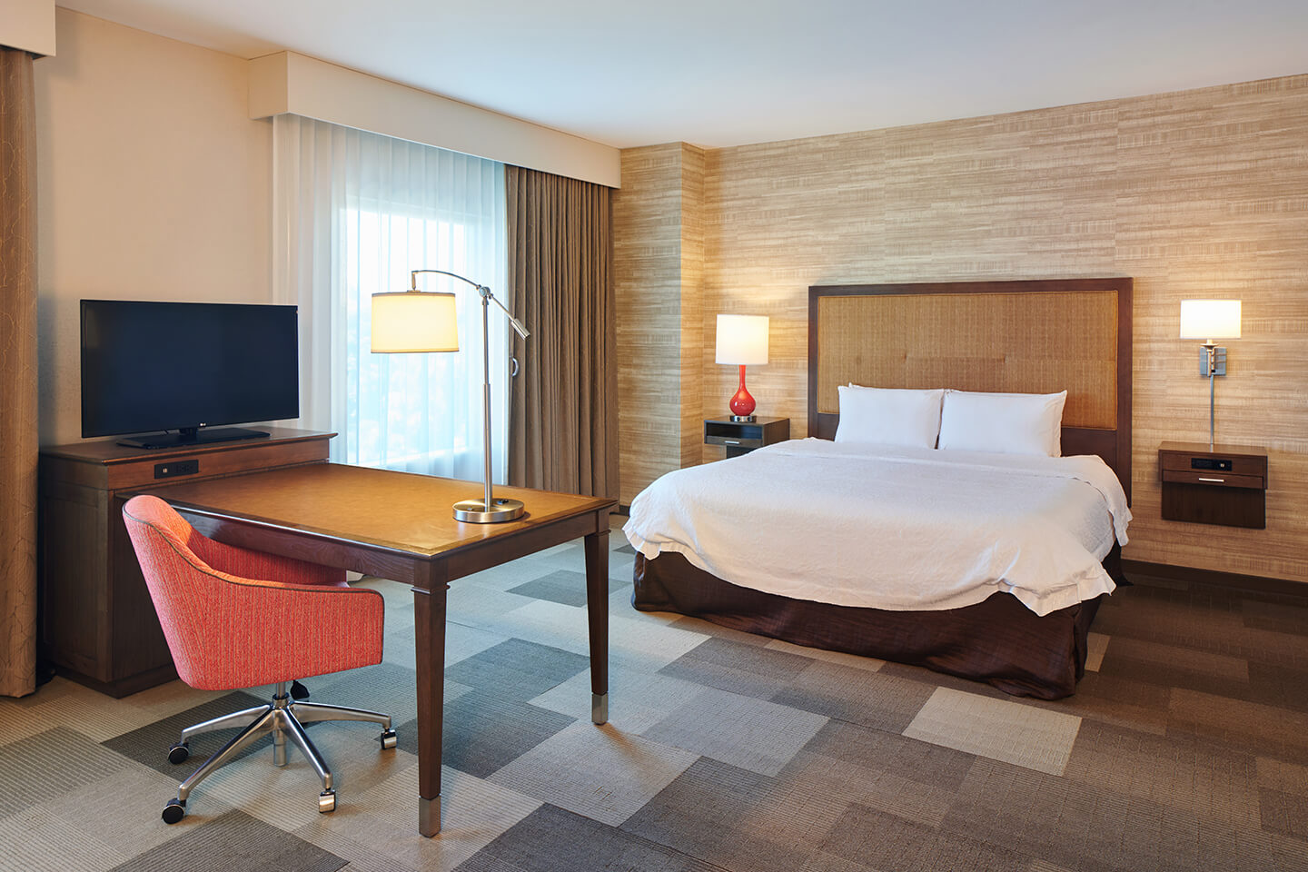 Room with bed, nightstands, lamps, desk, chair, TV