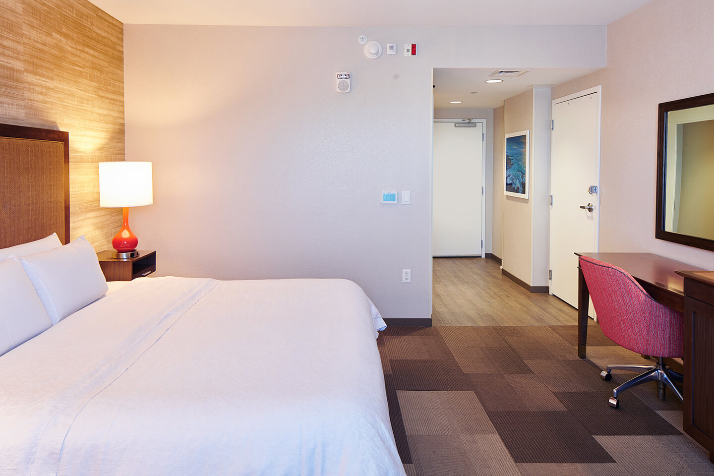Room with bed, lamp, desk, chair