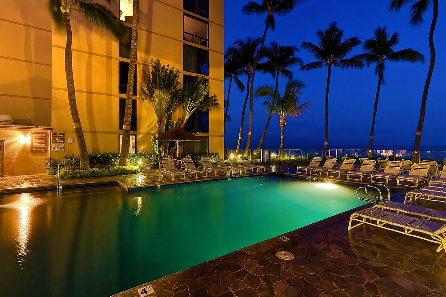 Evening photo of pool and deck.
