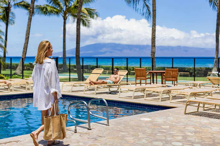 Woman walking along the pool deck.