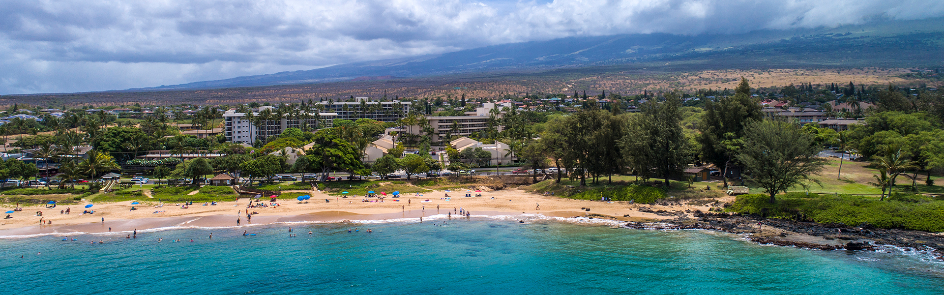 Aerial view of resort, mountains, and beachfront