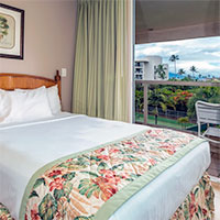 Room with bed and patio with table and seats