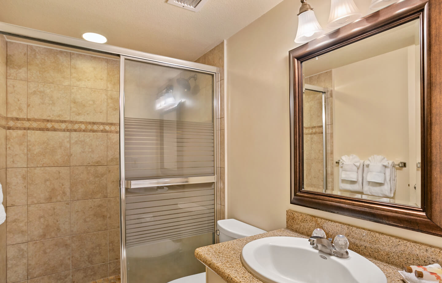Bathroom sink, counters, toilet, shower.