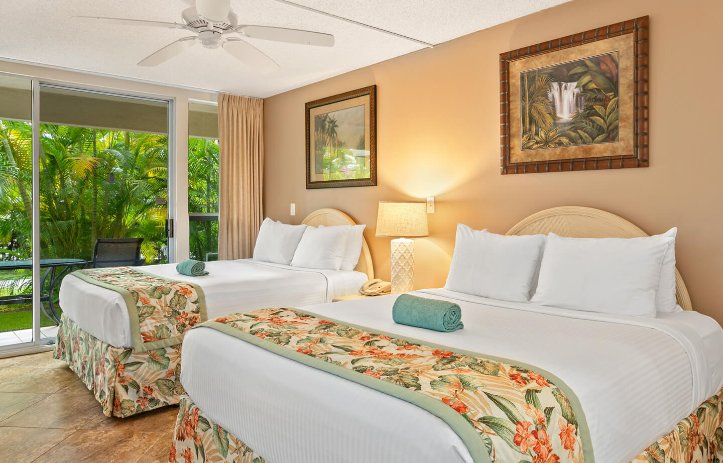 Room with 2 beds, nightstand, lamps, and patio.