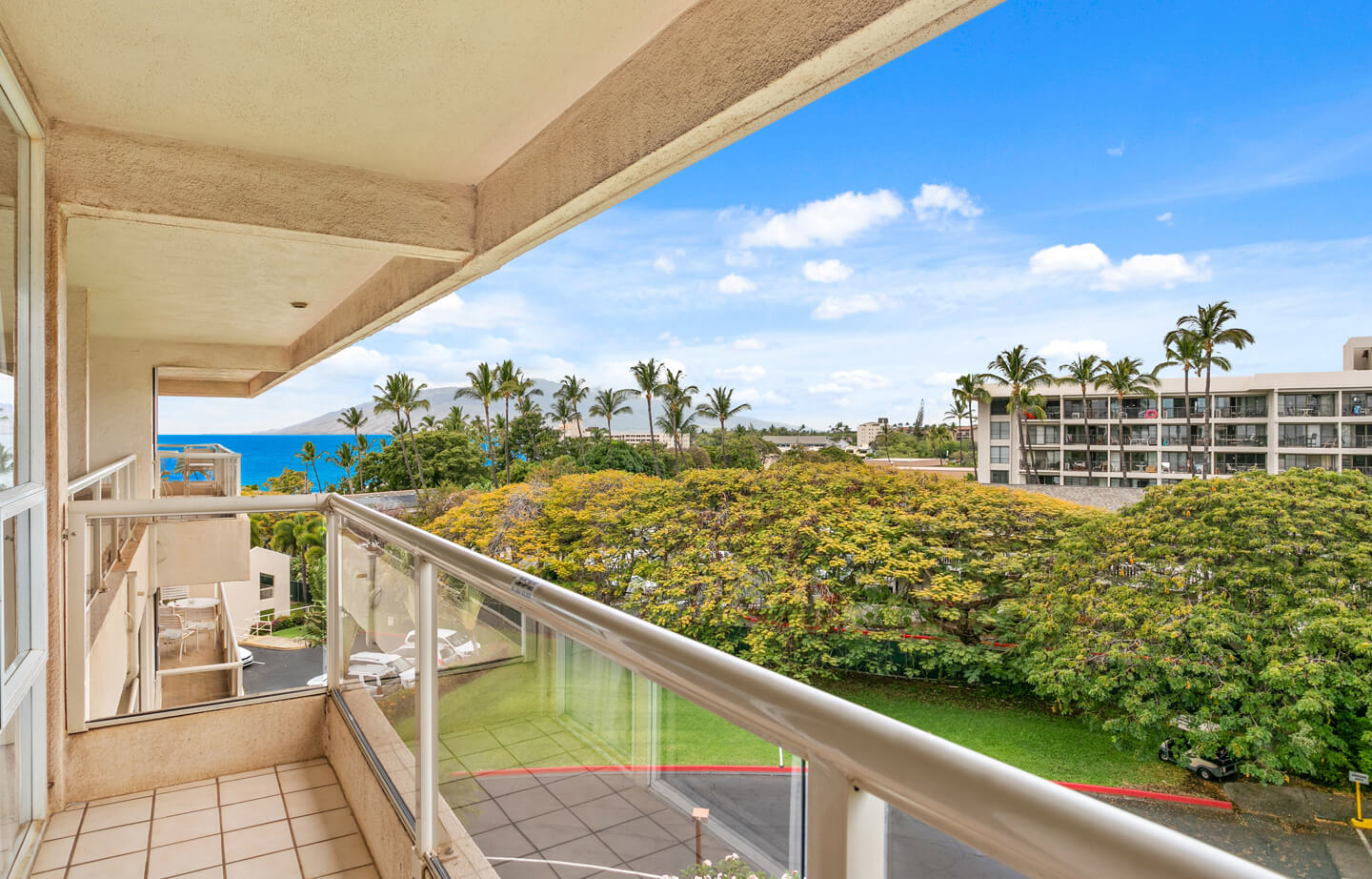 Balcony with view of resort gardens and ocean.