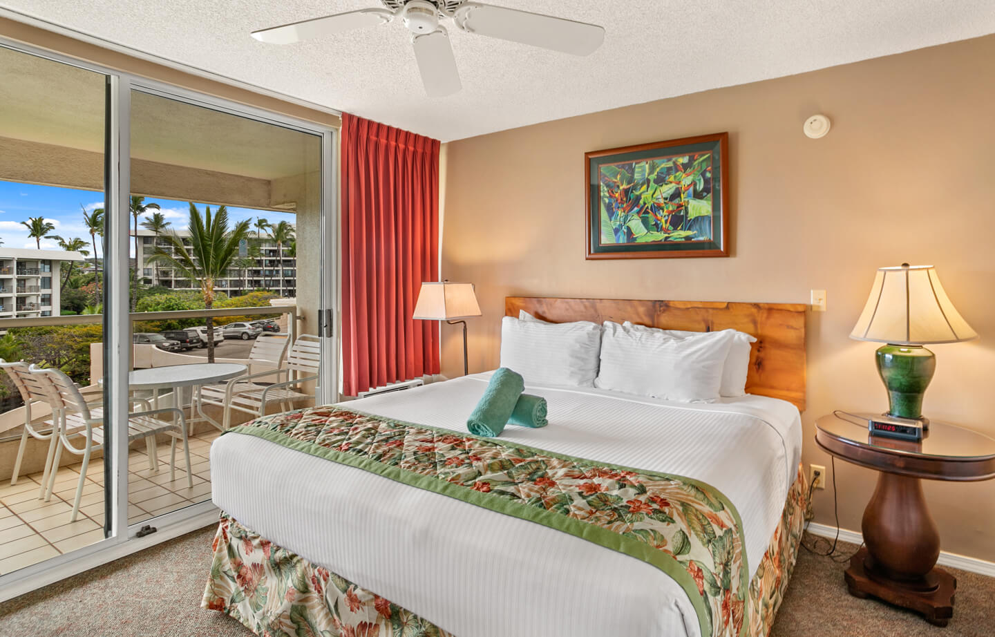 Room with bed, night stand, lamps, balcony.