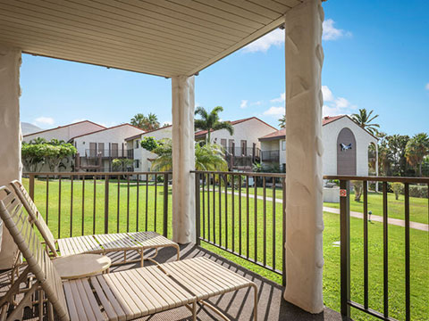 Balcony with loungers and view of resort grounds.