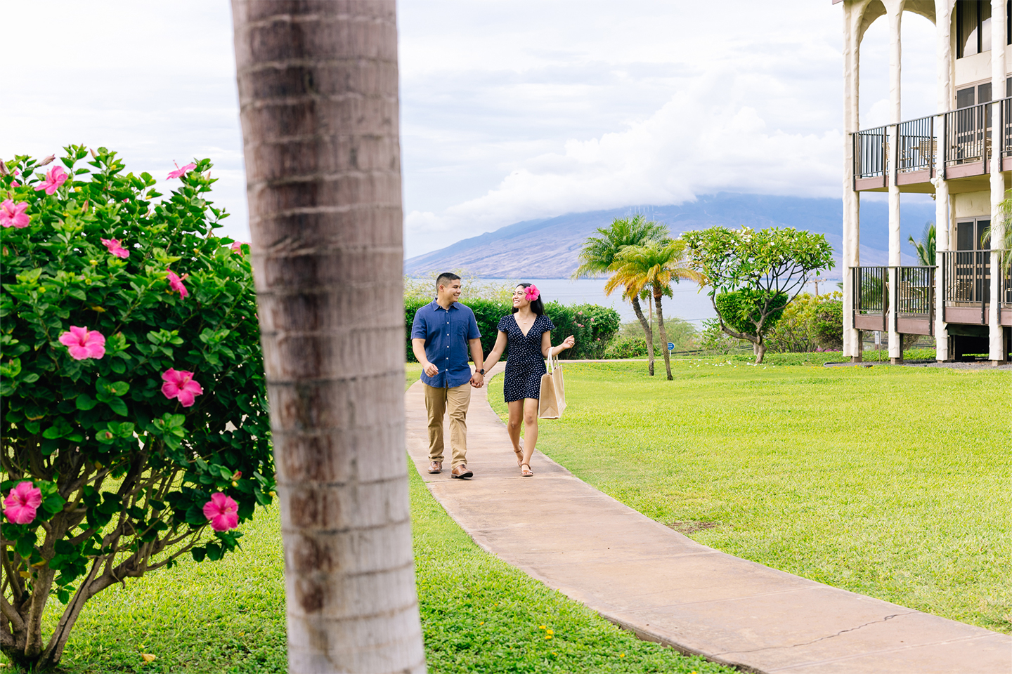 couple walking along path on resort grounds.