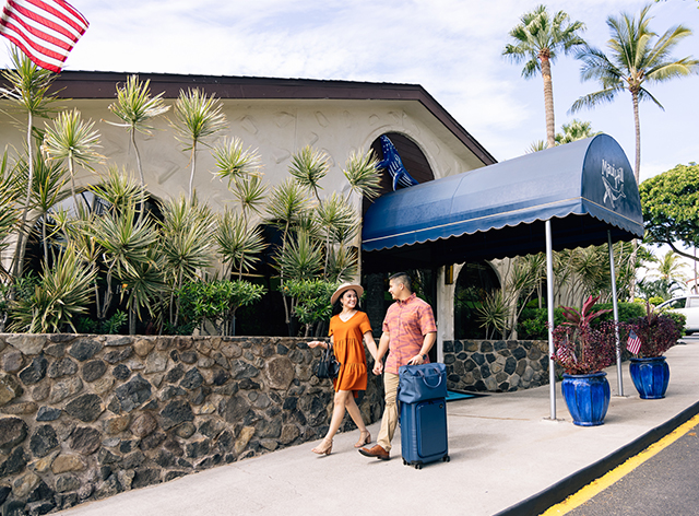 couple walking with luggage