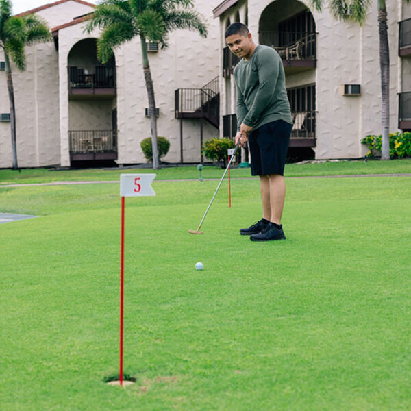 Man putting on golf green.