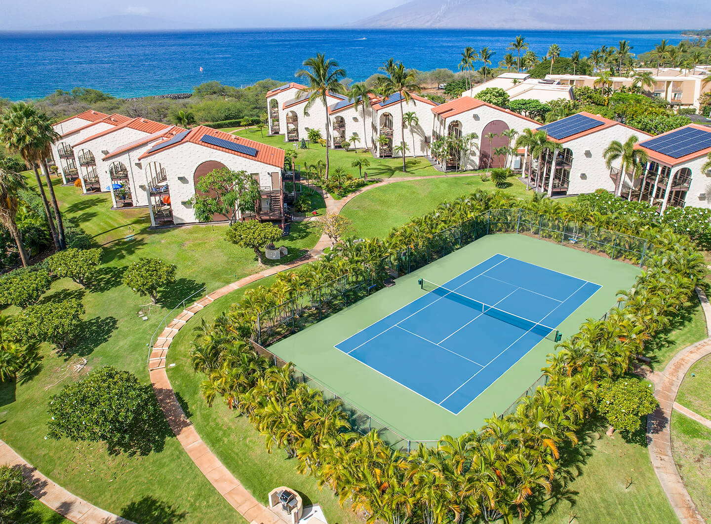 Aerial view of tennis court and resort.