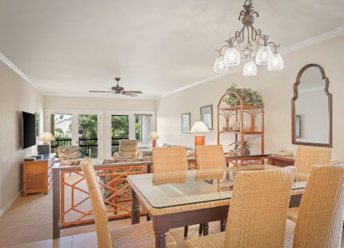 Dining area with seating for six that opens to a separate living area space with sofa, television and a coffee table