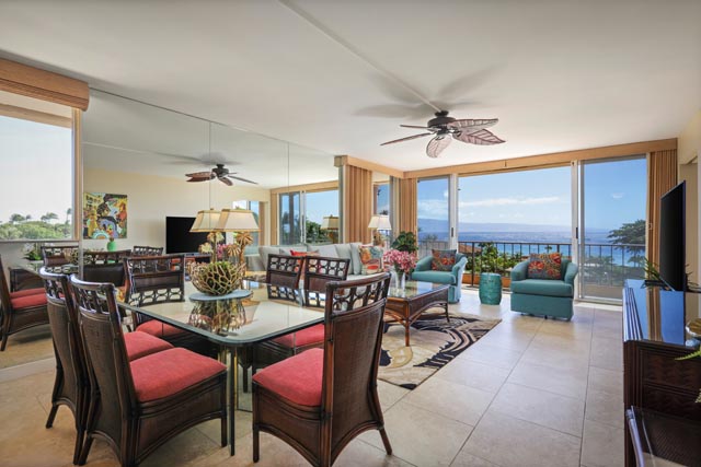 DIning and living area with tables, chairs, TV, chairs, balcony