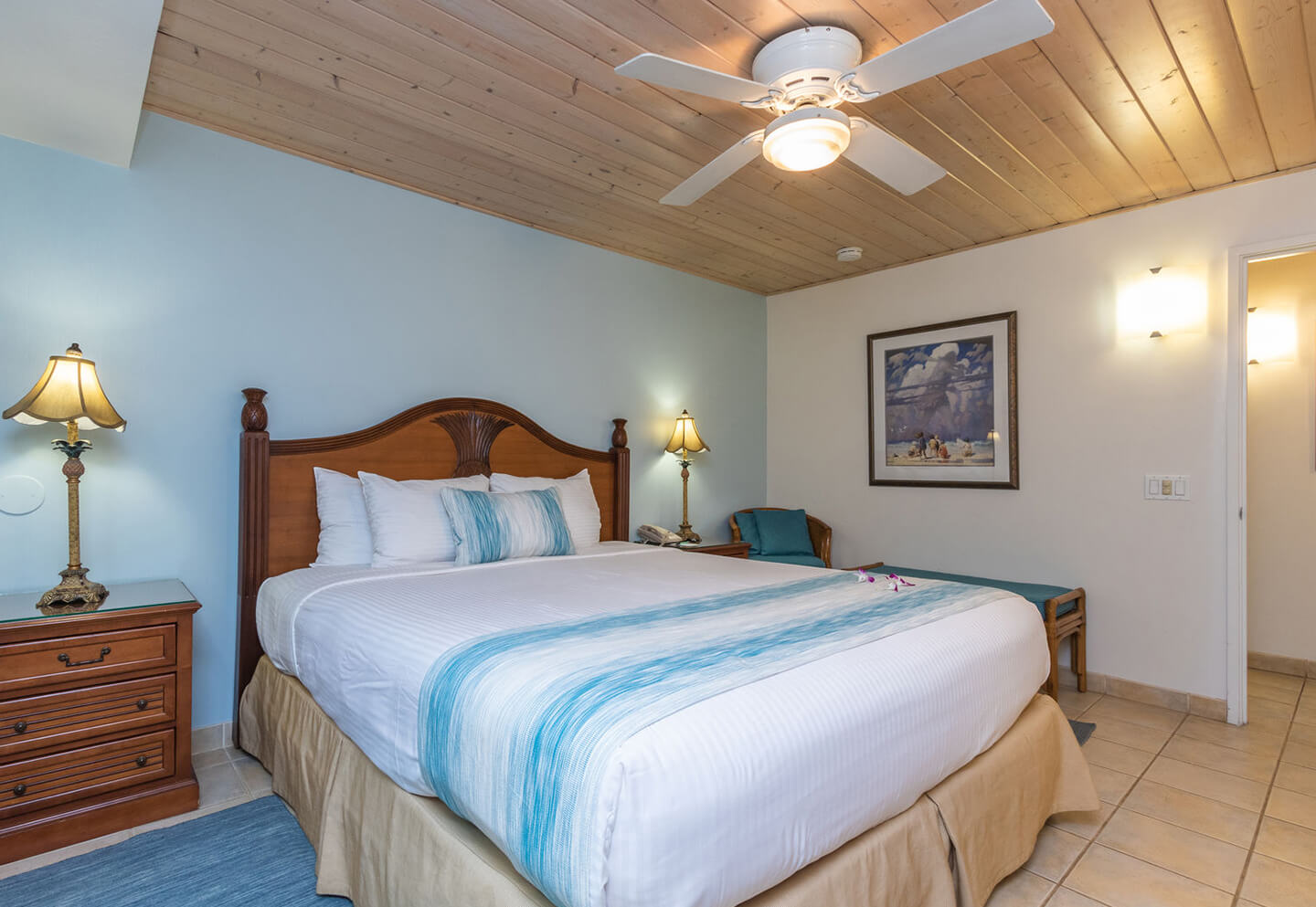 Room with a bed, night stand, and lamps.