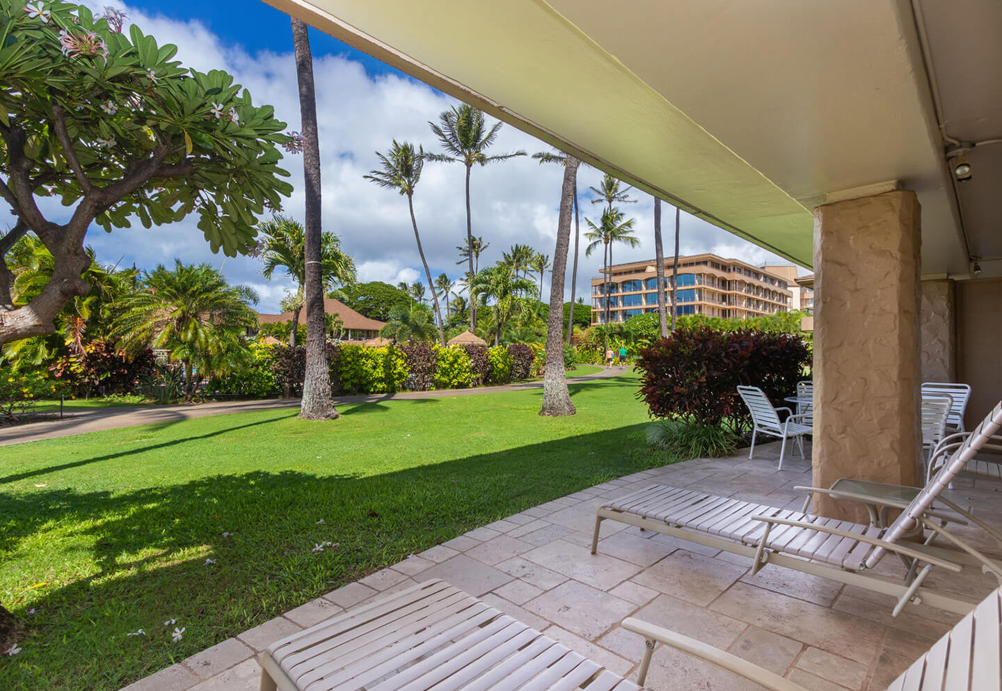 Patio with loungers and garden views.