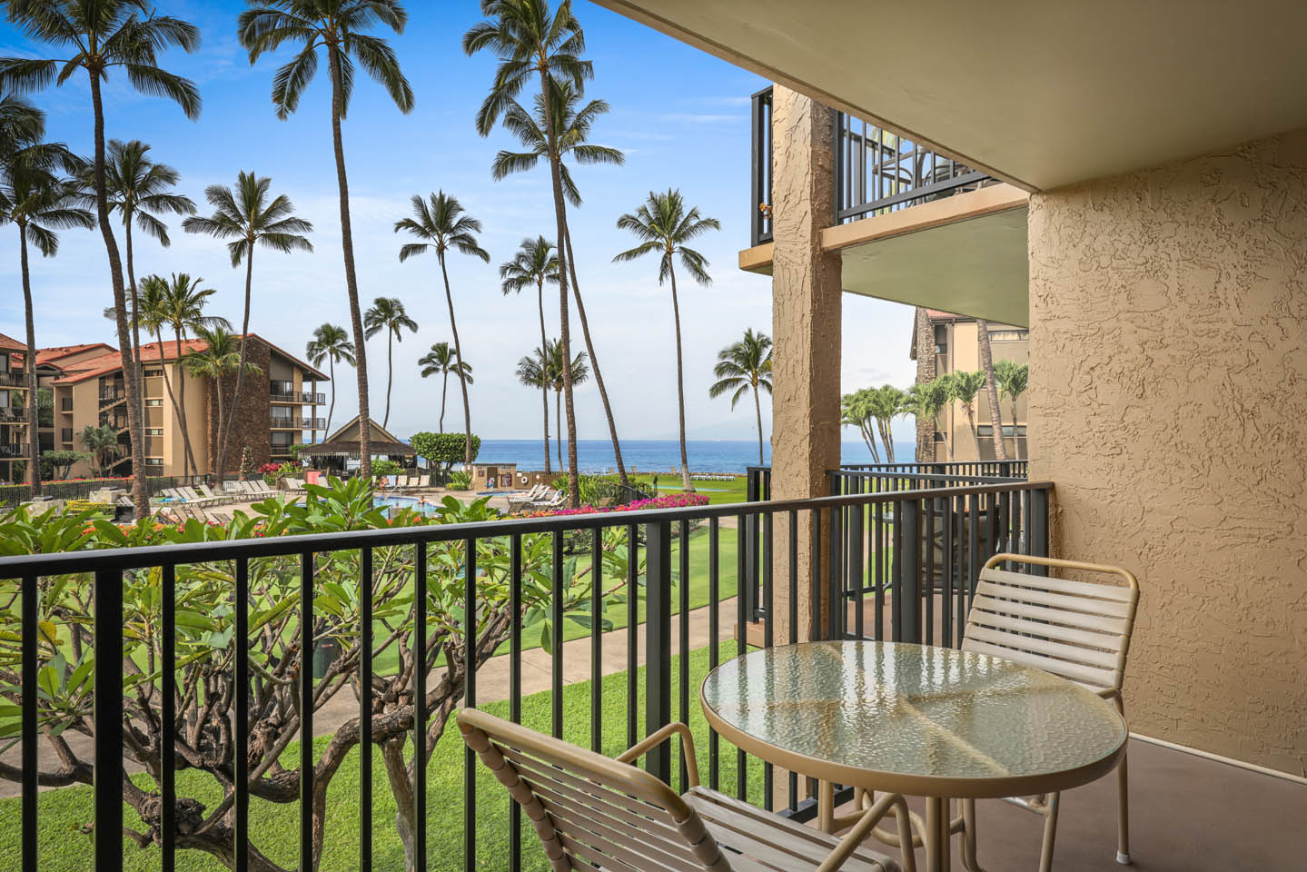 Balcony with table, chairs, and ocean views.