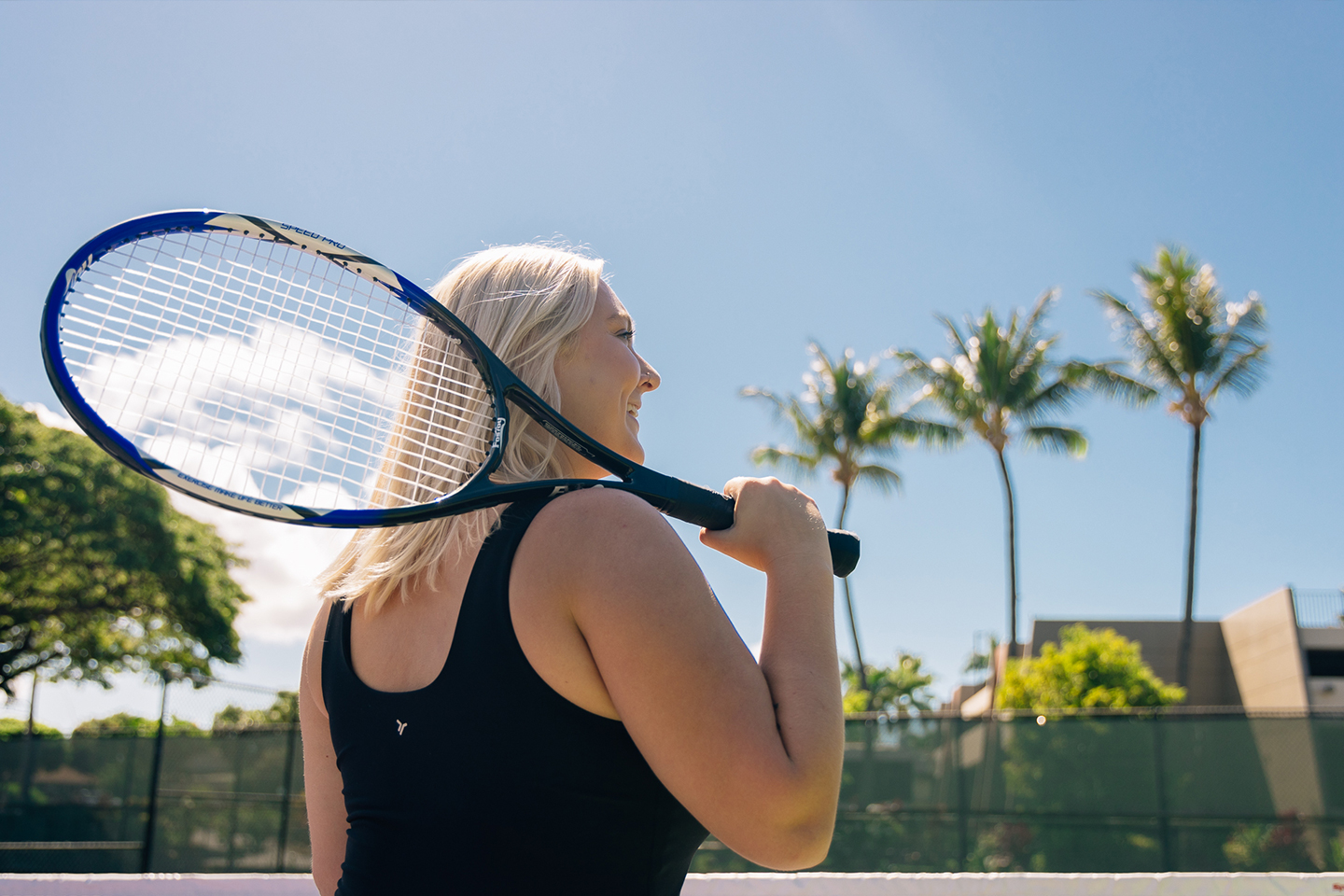 Woman holding tennis racquet.
