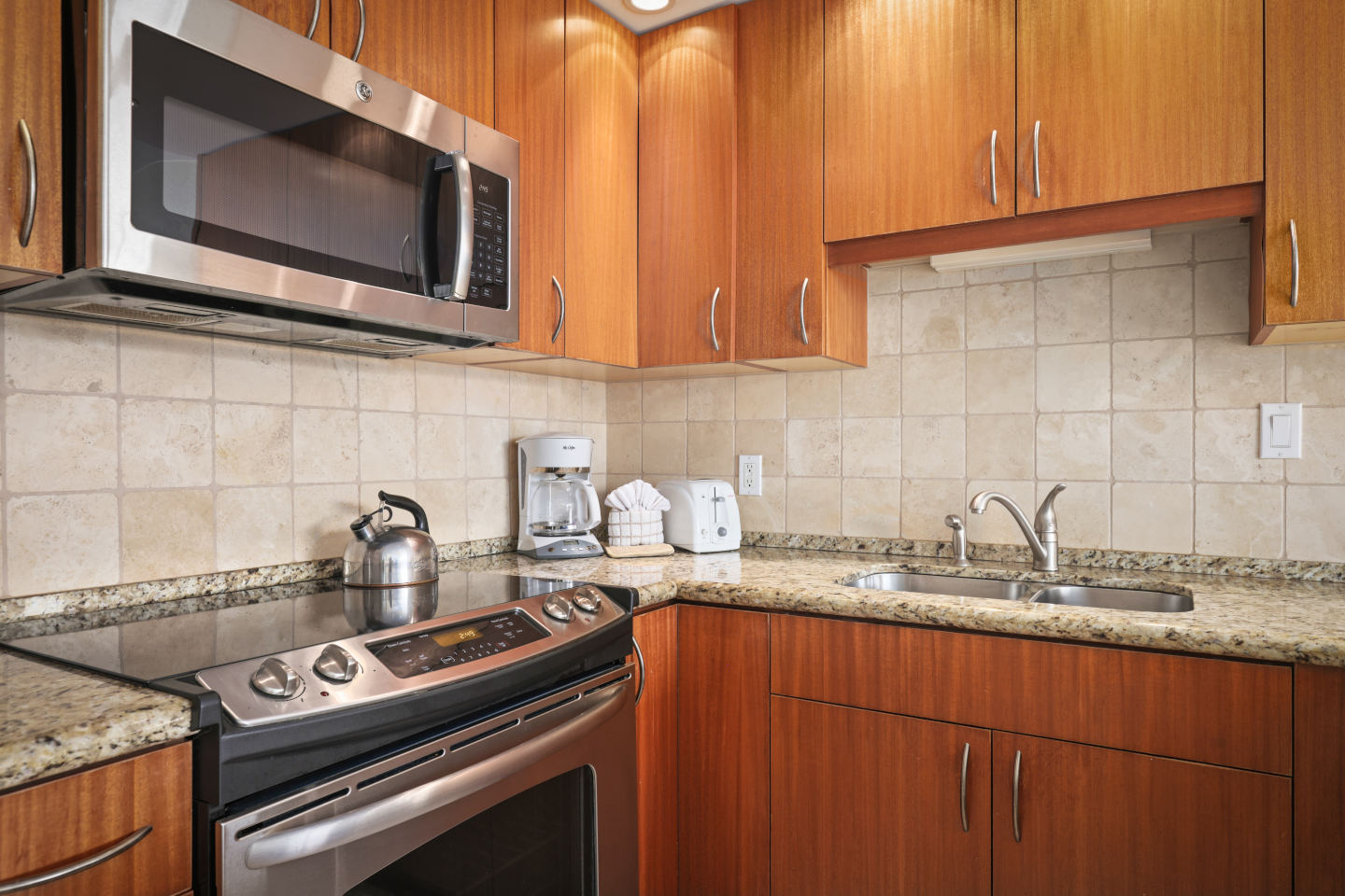 Kitchen with stove, oven, microwave, sink.