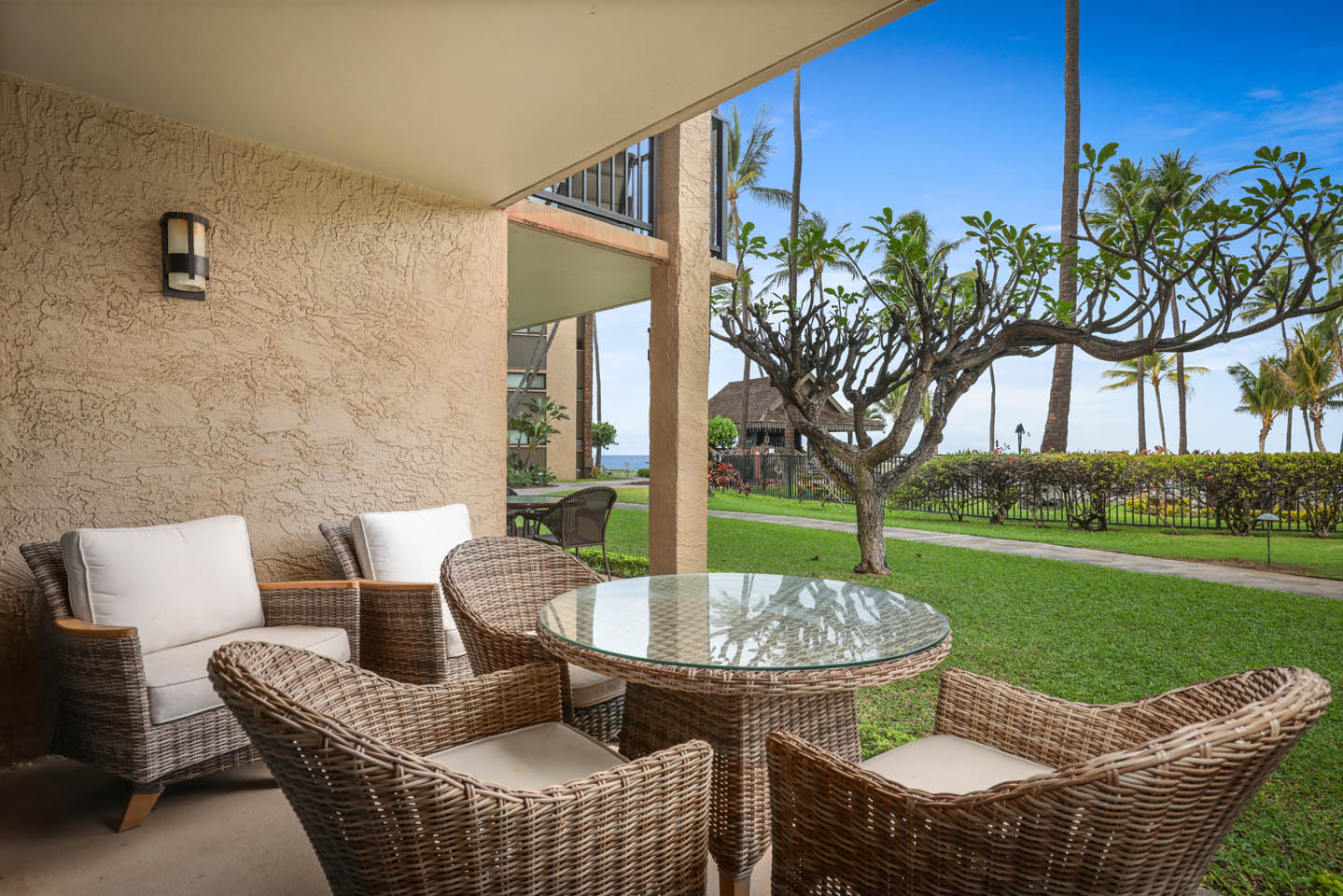 Patio with seating, table, garden views.