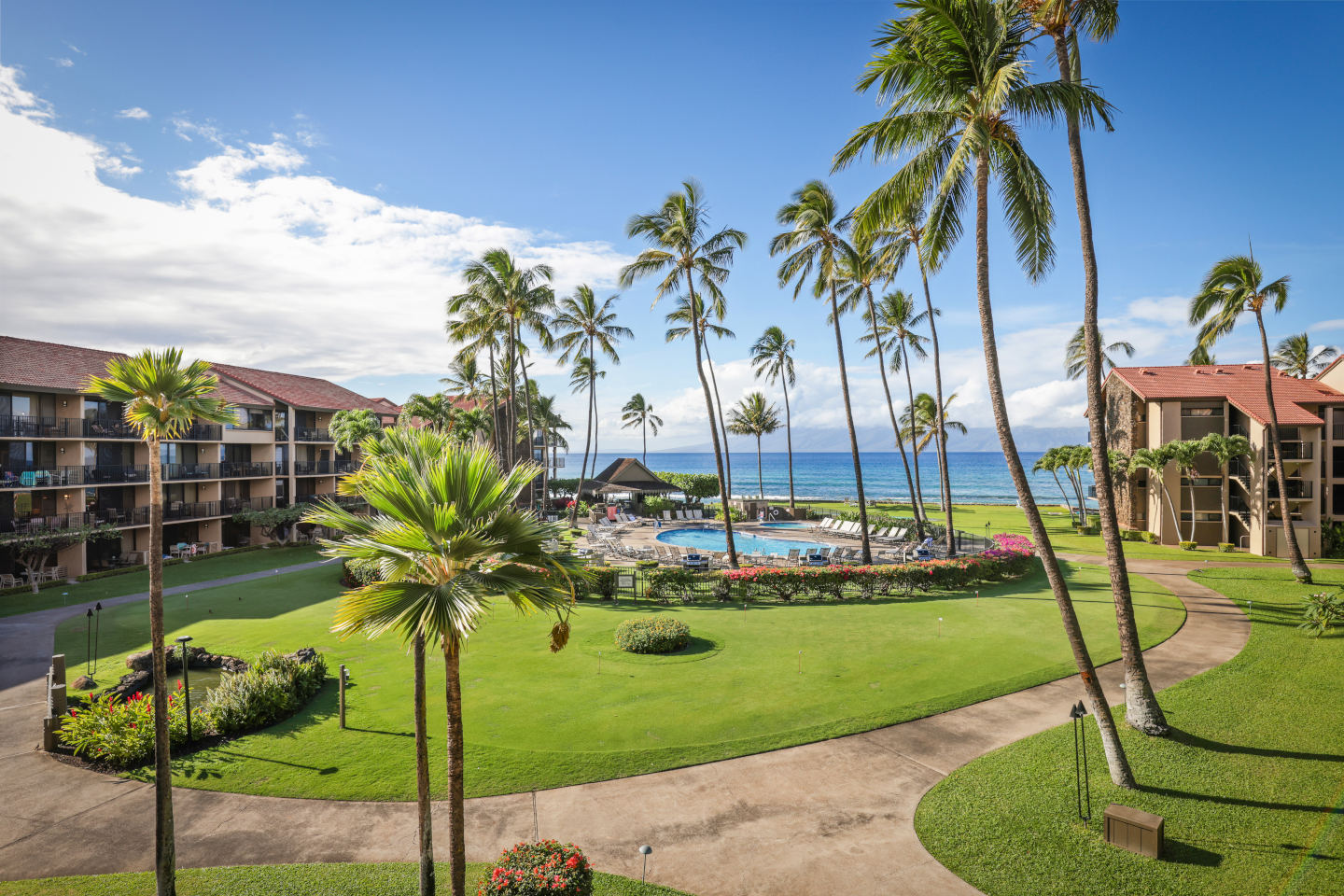 Views of resort grounds, pool, and ocean from balcony.