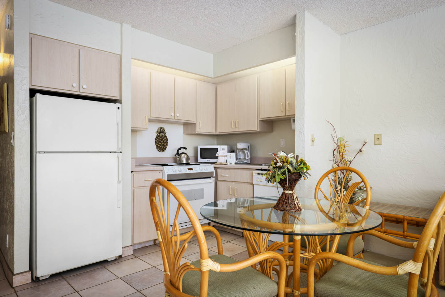 Dining area with table, chairs, and full kitchen.