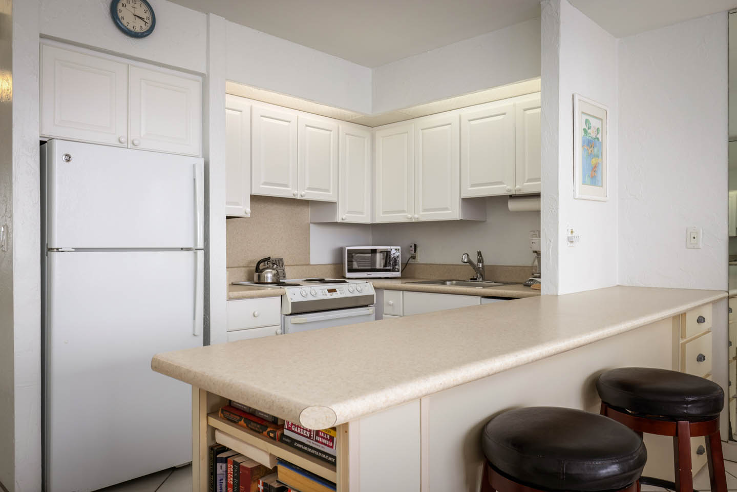 Kitchen with counter and seating.