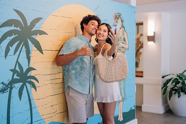 Couple taking selfie in hotel lobby