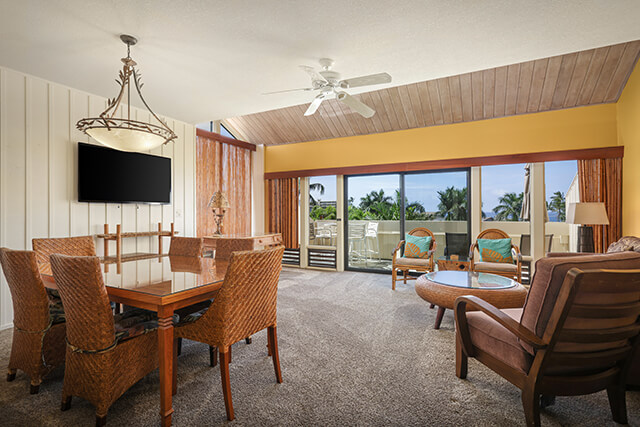 Dining area with table and chairs and living area with seating and TV