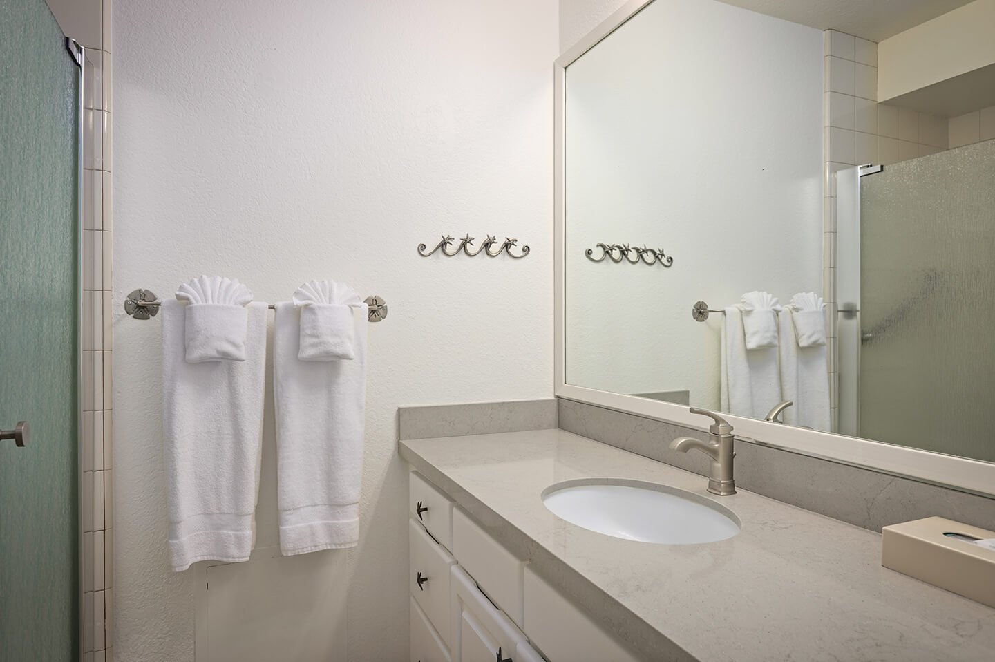 Bathroom counter top, sink, and shower.