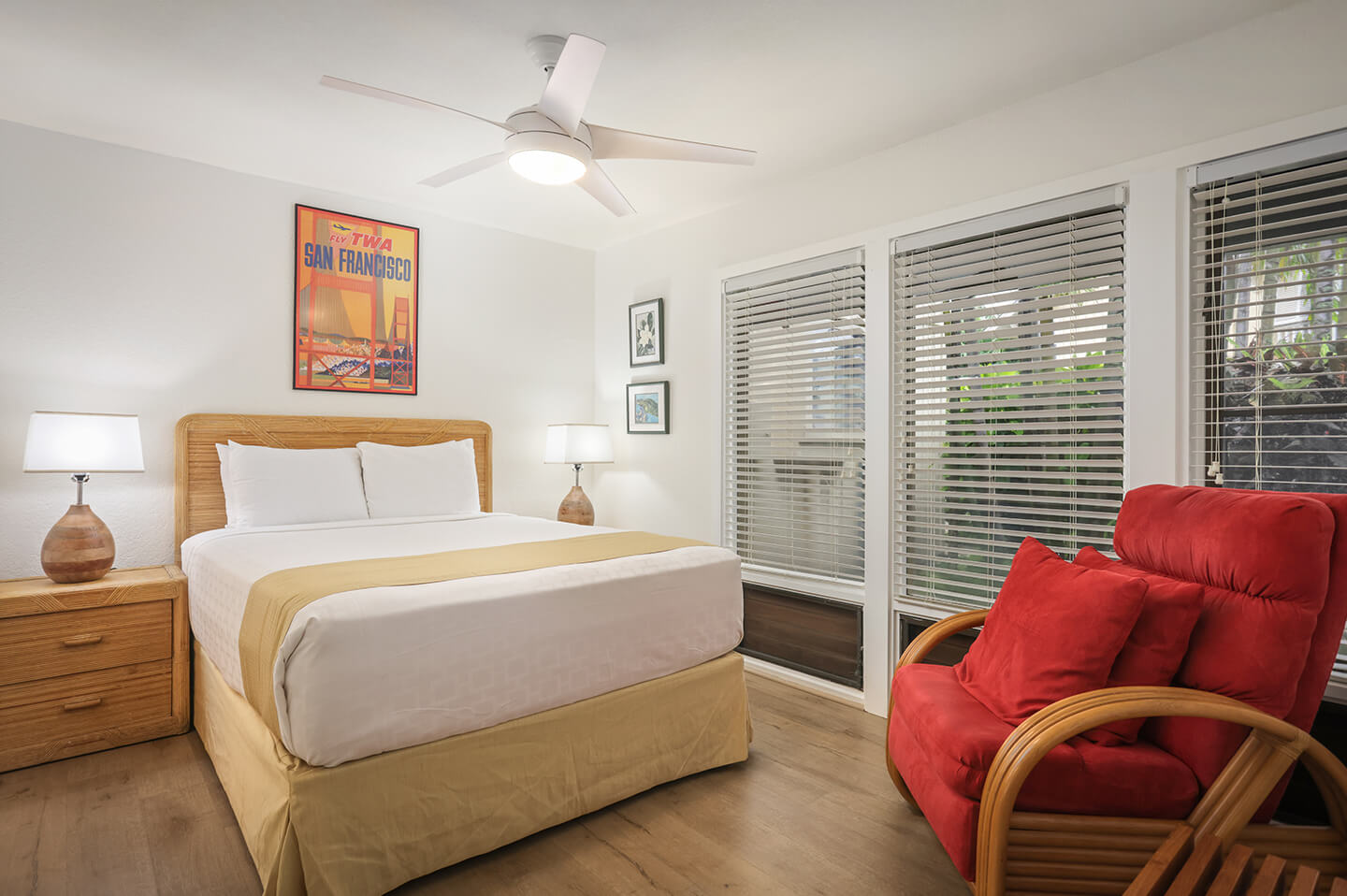 Room with bed, nightstand, lamp, seating.